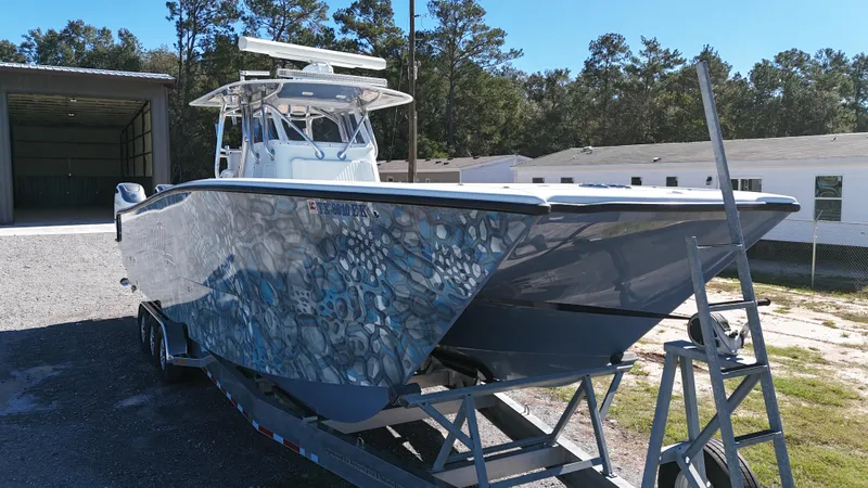 Slide: The Image of 2016 Freeman 37VH boat on trailer, parked outdoors near a building. - 1