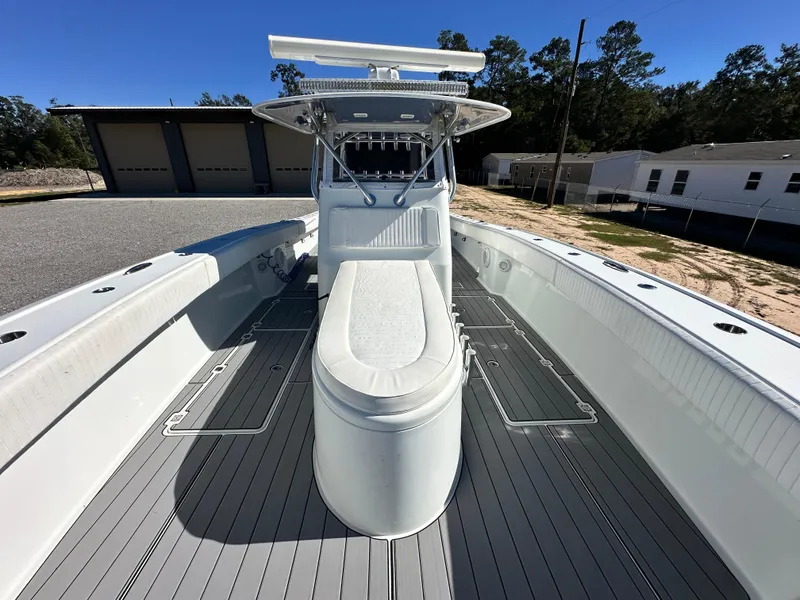 Slide: The Image of 2016 Freeman 37VH boat with spacious deck and seating, parked outdoors. - 18