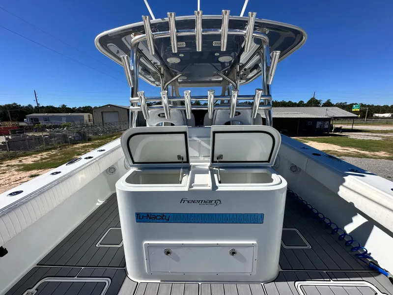 Slide: The Image of 2016 Freeman 37VH boat with open storage compartments, sleek design, and spacious deck. - 25