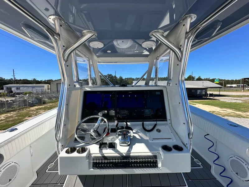 Slide: The Image of 2016 Freeman 37VH boat cockpit with steering wheel and control panel. - 28