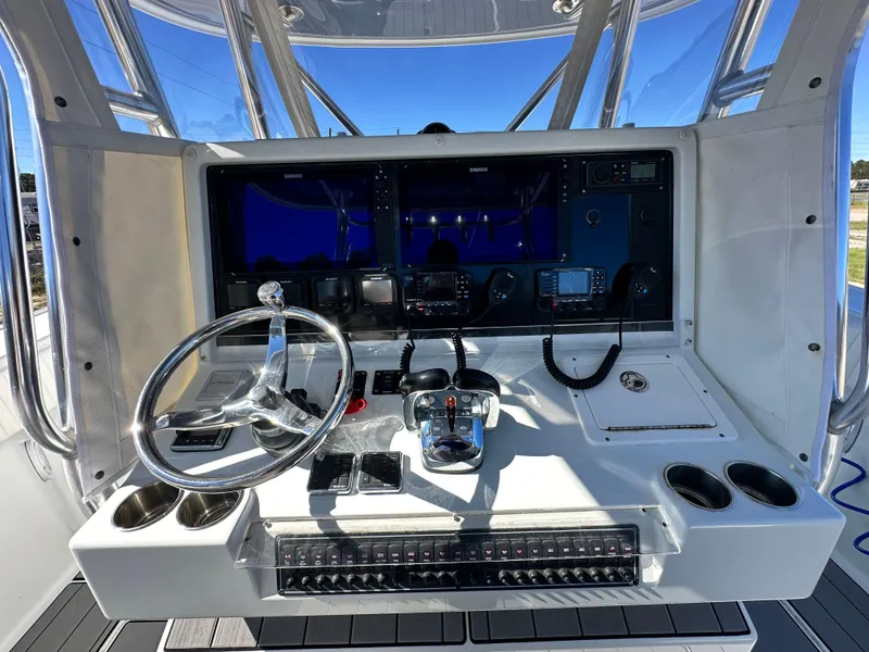 Slide: The Image of Freeman 37VH 2016 boat dashboard with steering wheel and navigation controls. - 30