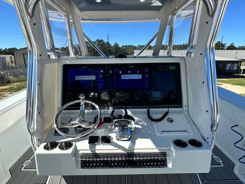 Slide: The Image of 2016 Freeman 37VH boat cockpit with steering wheel and navigation screens. - 31