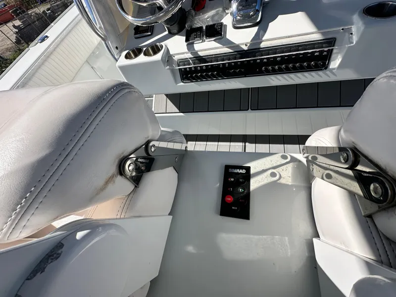 Slide: The Image of Freeman 37VH 2016 boat interior with white seats and control panel. - 32