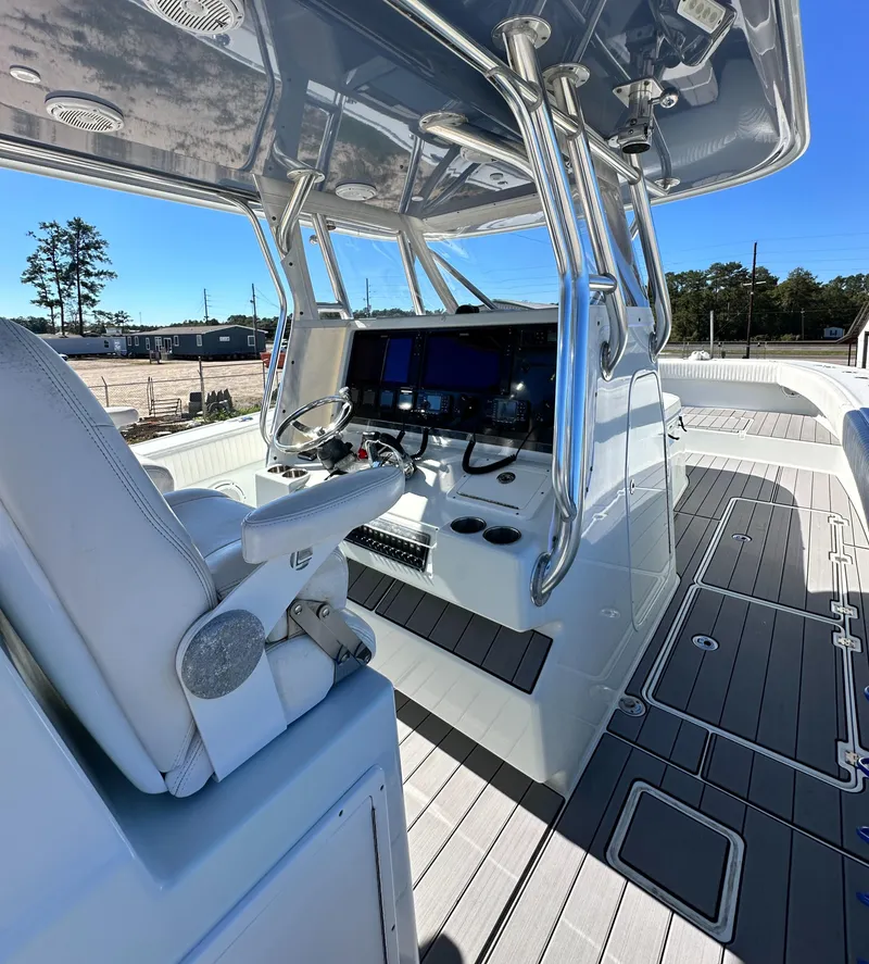 Slide: The Image of 2016 Freeman 37VH boat cockpit with modern navigation equipment and seating. - 33