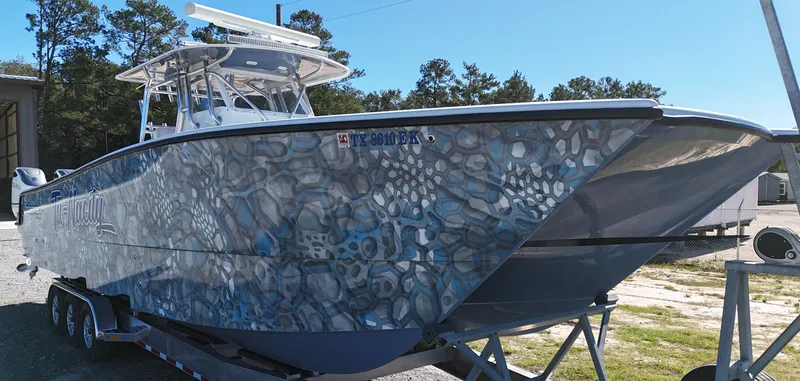Slide: The Image of 2016 Freeman 37VH boat with unique patterned hull on a trailer. - 4