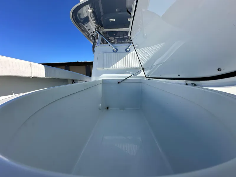 Slide: The Image of Open storage compartment on a 2016 Freeman 37VH boat under clear blue sky. - 47