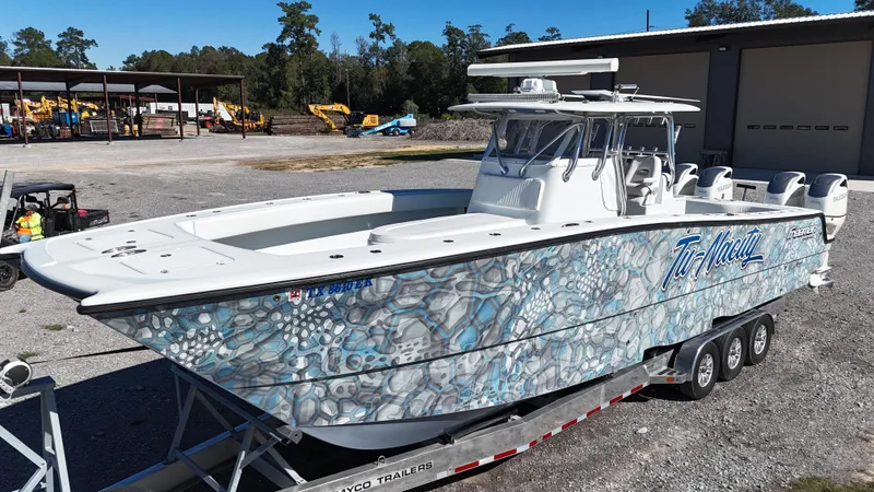 Slide: The Image of Freeman 37VH 2016 boat with unique blue pattern on trailer in outdoor setting. - 8