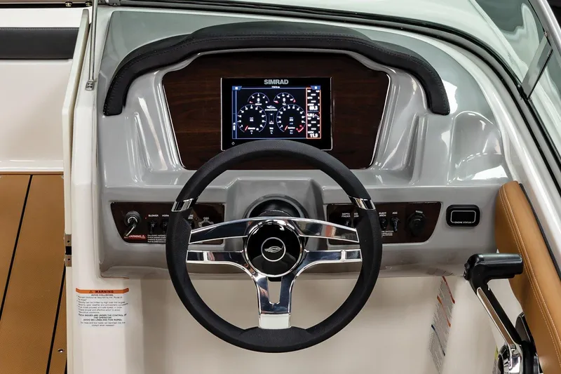 Slide: The Image of 2025 Chaparral 21 SSi boat dashboard with steering wheel and digital display. - 12