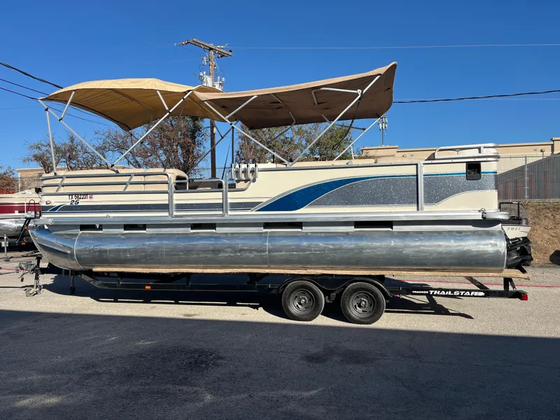 Slide: The Image of 2001 Sun Tracker PARTY BARGE 25 pontoon boat on trailer, beige and blue design. - 15