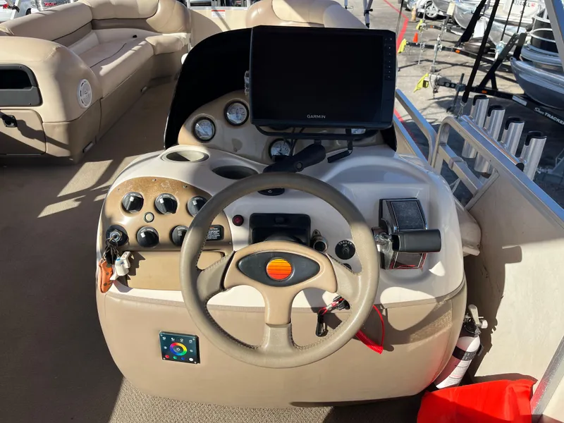 Slide: The Image of 2001 Sun Tracker PARTY BARGE 25 boat dashboard with steering wheel and controls. - 19
