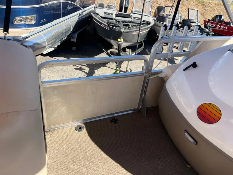 Slide: The Image of 2001 Sun Tracker PARTY BARGE 25 pontoon boat interior with railing and carpeted deck. - 26