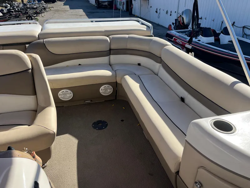 Slide: The Image of 2001 Sun Tracker PARTY BARGE 25 interior with beige seating and cup holders. - 31