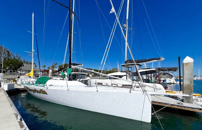 Slide: The Image of White sailboat docked at marina, Custom Modified In 2003 SLP 52, 1989 model. - 3