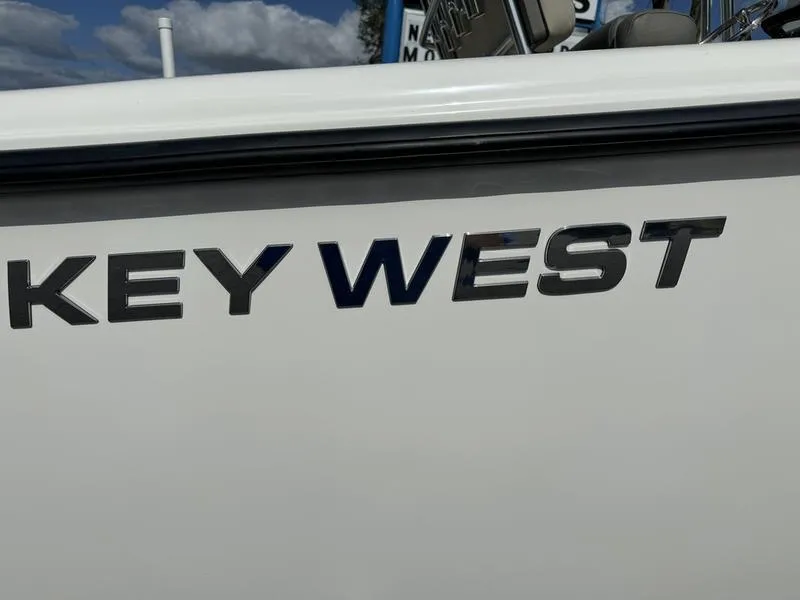 Slide: The Image of 2025 Key West 244 CC boat logo on white surface under blue sky. - 5