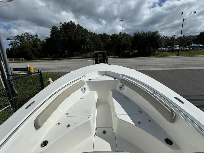 Slide: The Image of 2025 Key West 244 CC boat with spacious deck and seating, parked outdoors. - 7