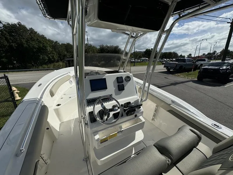 Slide: The Image of 2025 Key West 244 CC boat interior with steering console and seating. - 9
