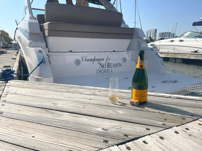 Slide: The Image of 2015 Regal 32 Express boat docked with champagne bottle and glass on pier. - 10