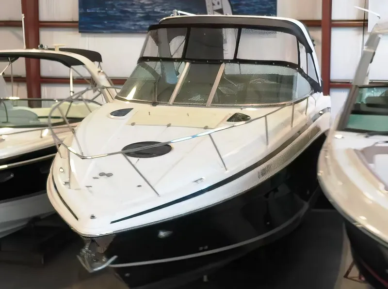 Slide: The Image of 2015 Regal 32 Express boat in showroom, sleek design, black and white exterior. - 9