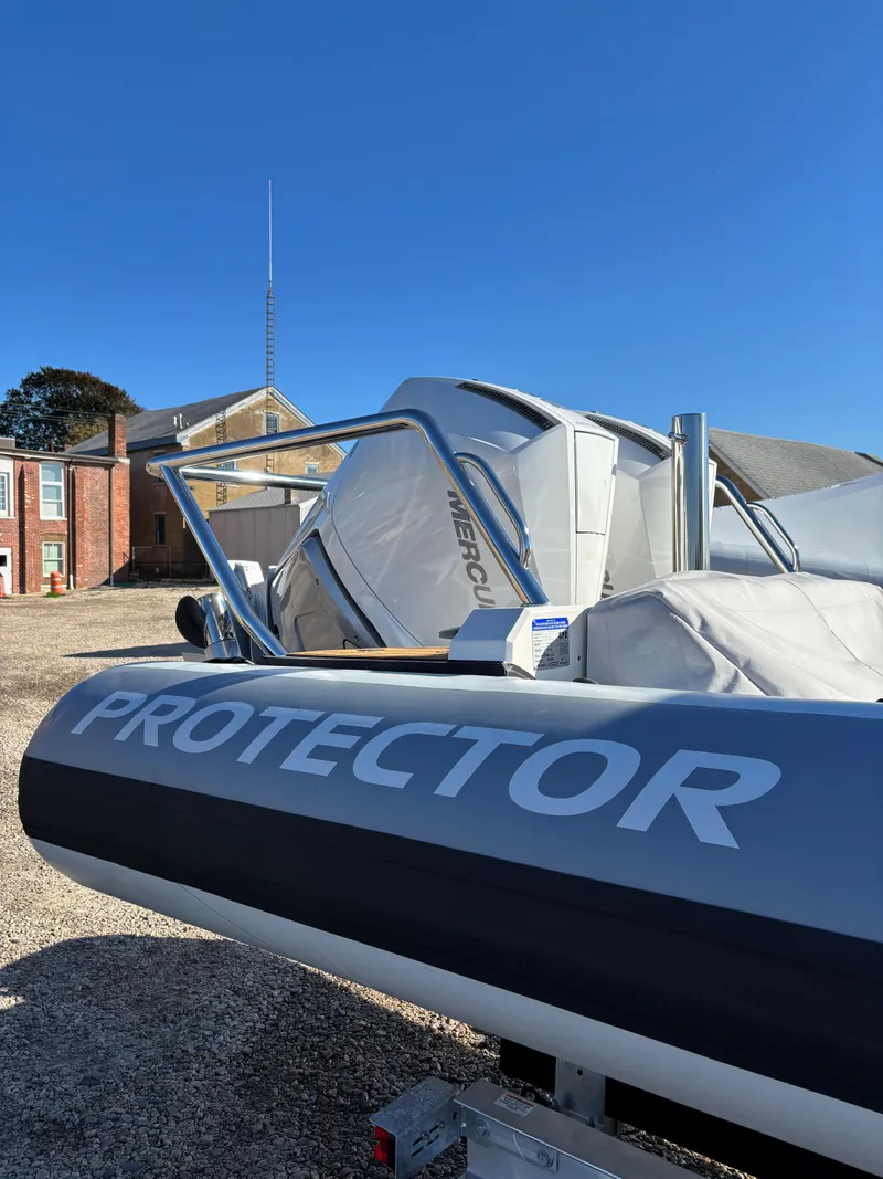 Slide: The Image of 2024 Protector 330 Chase boat in a sunny outdoor setting. - 13