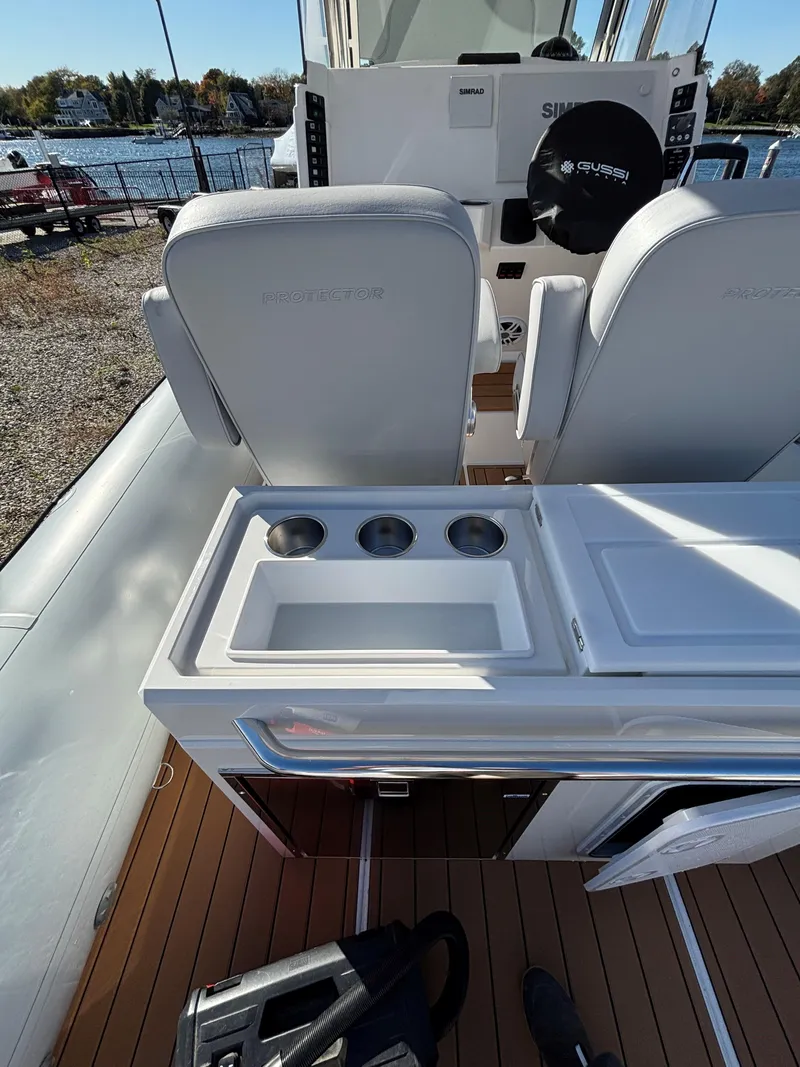 Slide: The Image of 2024 Protector 330 Chase boat interior with seating and utility area. - 18