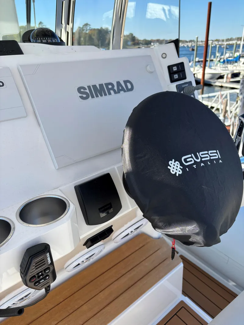 Slide: The Image of 2024 Protector 330 Chase boat dashboard with Simrad and Gussi Italia equipment. - 21