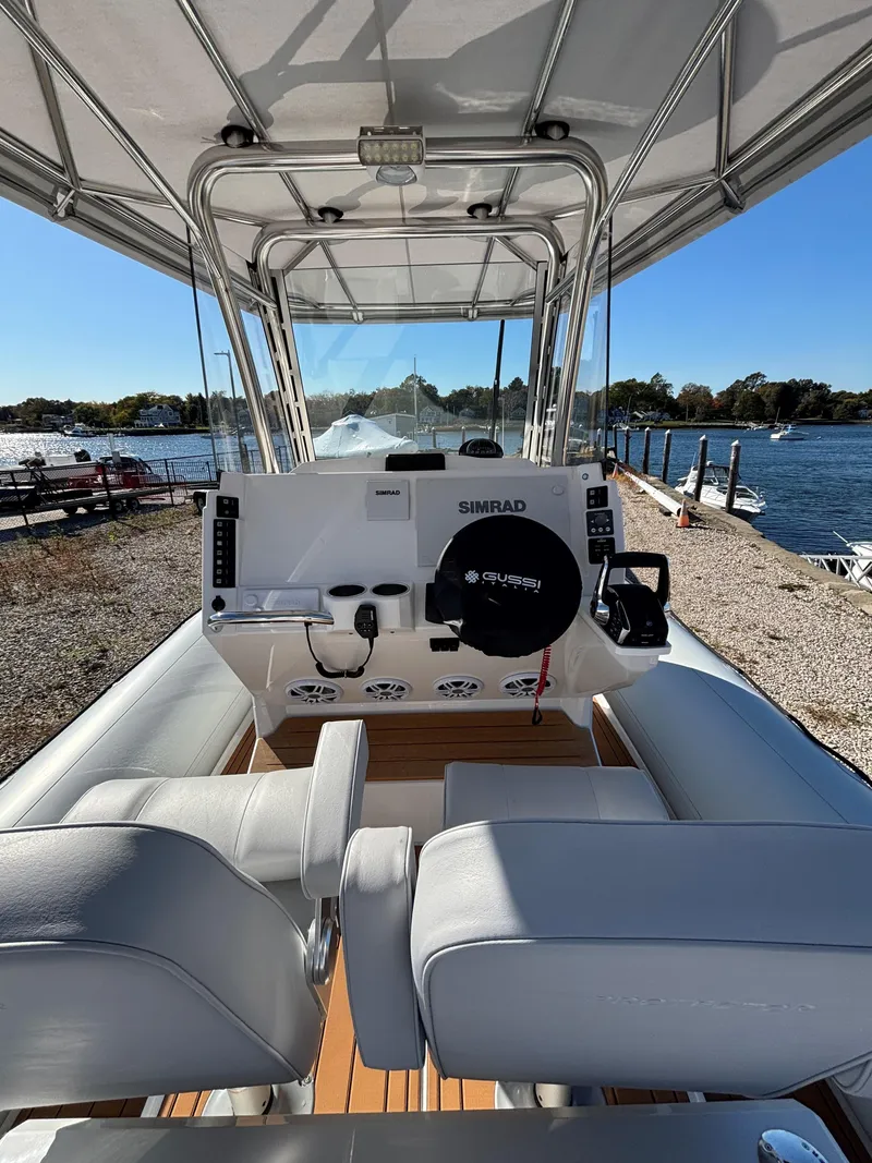 Slide: The Image of 2024 Protector 330 Chase boat interior with steering console, dockside view. - 22