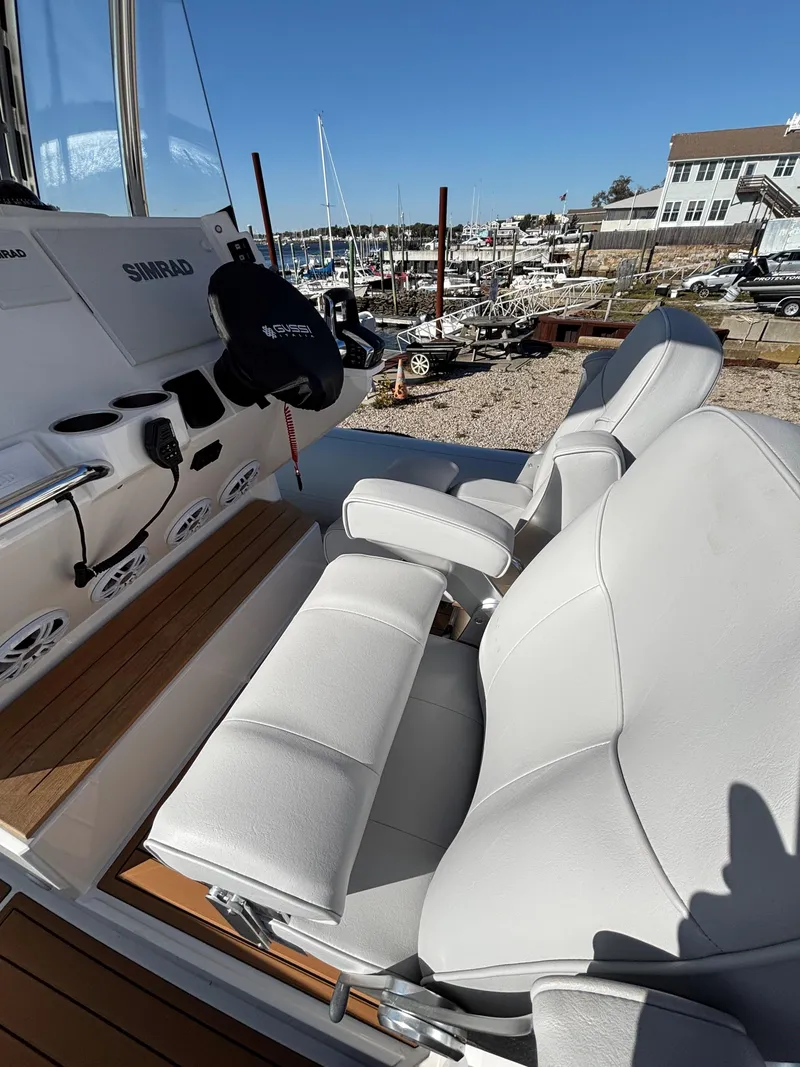 Slide: The Image of Luxury seating on 2024 Protector 330 Chase boat, docked at marina. - 23