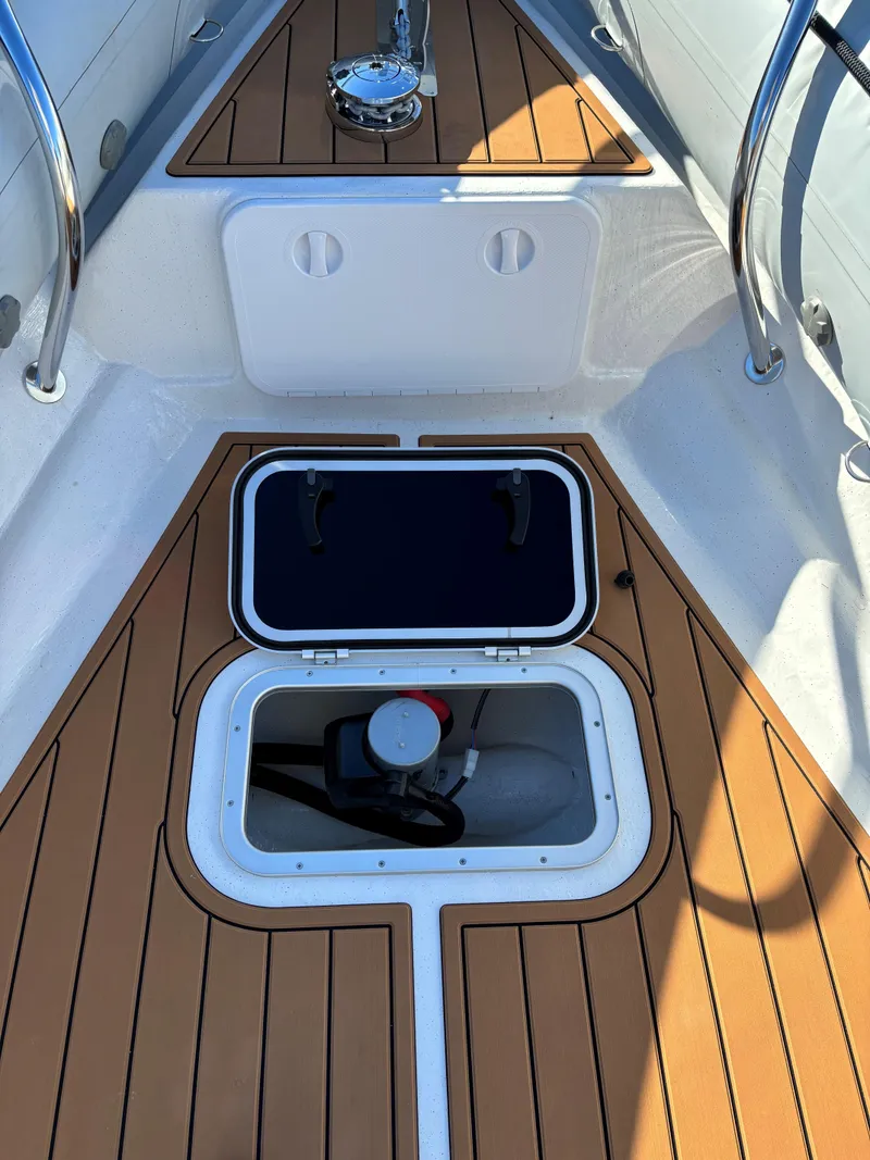 Slide: The Image of 2024 Protector 330 Chase boat deck with open storage compartment. - 27