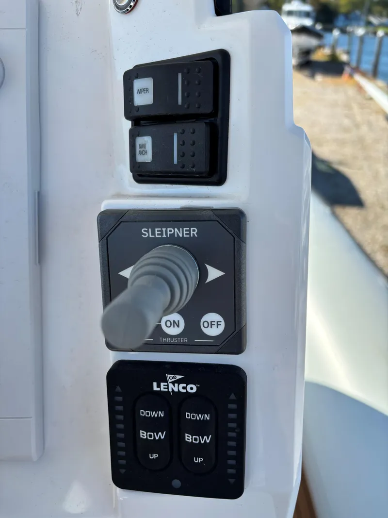 Slide: The Image of Control panel of 2024 Protector 330 Chase boat with Sleipner joystick and Lenco trim tabs. - 4