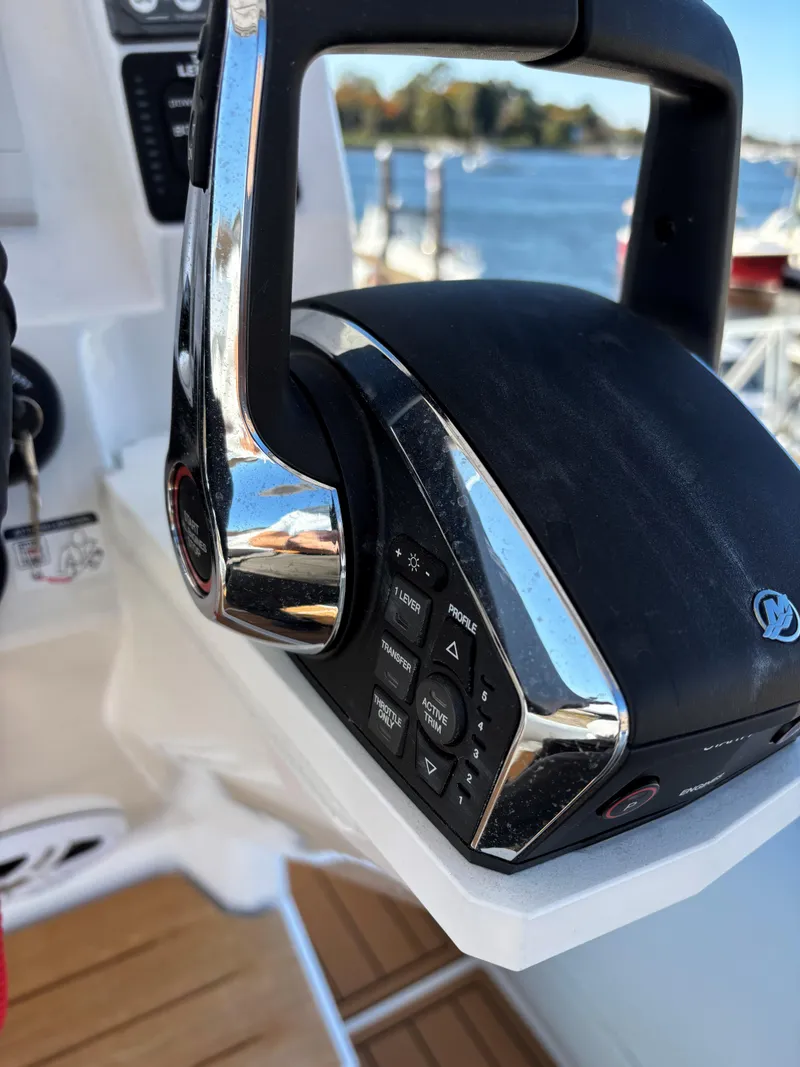 Slide: The Image of Close-up of 2024 Protector 330 Chase boat throttle control on deck. - 5