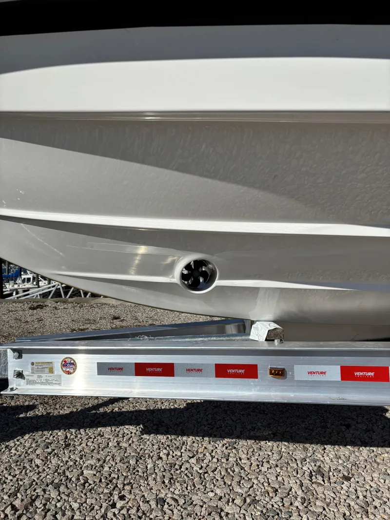 Slide: The Image of 2024 Protector 330 Chase boat hull on trailer, close-up view. - 9
