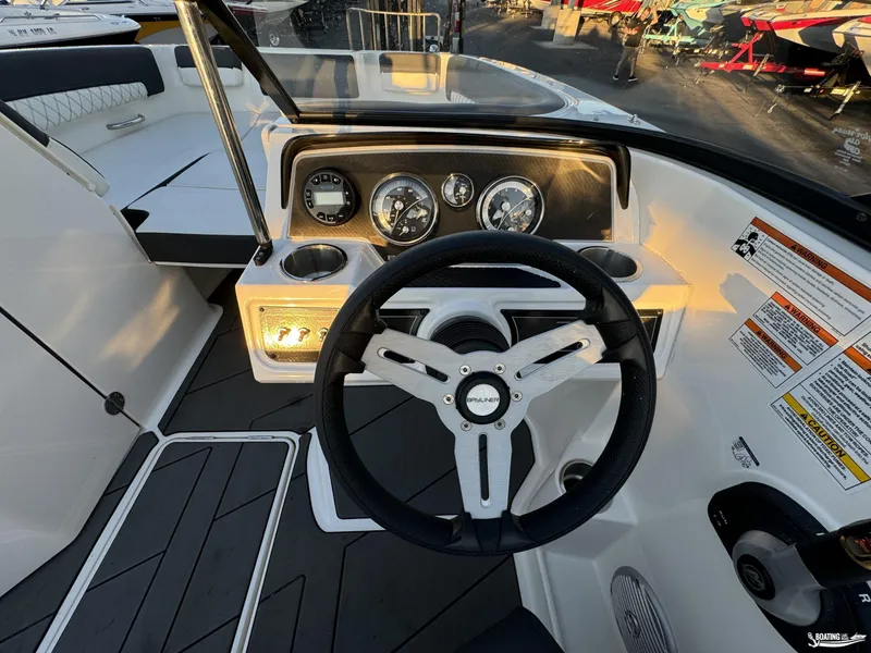 Slide: The Image of 2020 Bayliner DX2250 boat dashboard with steering wheel and gauges. - 10