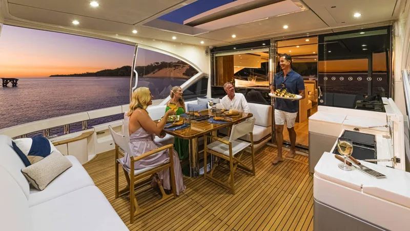 Slide: The Image of Luxury dining on 2025 Riviera 6800 Sport Yacht at sunset. - 14