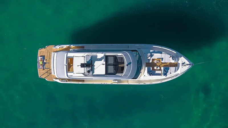 Slide: The Image of Aerial view of 2025 Riviera 6800 Sport Yacht Platinum Edition on turquoise water. - 8