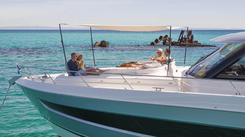 Slide: The Image of 2025 Riviera 6800 Sport Yacht Platinum Edition cruising on turquoise waters. - 9