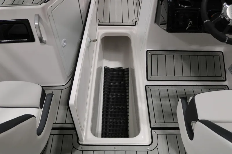 Slide: The Image of 2025 Yamaha Boats 195S interior storage compartment with sleek design and seating. - 16