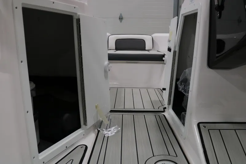 Slide: The Image of 2025 Yamaha Boats 195S interior with open storage compartments and cushioned seating. - 17
