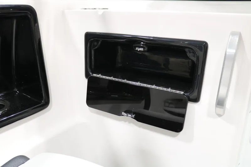 Slide: The Image of 2025 Yamaha Boats 195S storage compartment with open black hatch. - 19