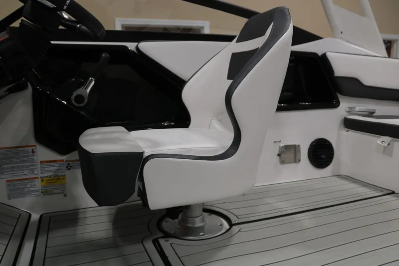 Slide: The Image of 2025 Yamaha Boats 195S interior with sleek white captain's chair and modern dashboard. - 21