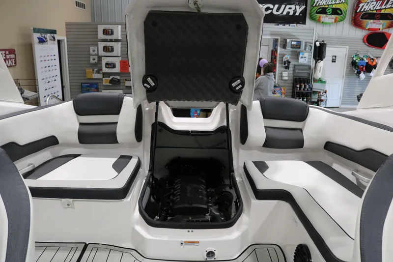 Slide: The Image of 2025 Yamaha Boats 195S interior with open engine compartment in showroom. - 27