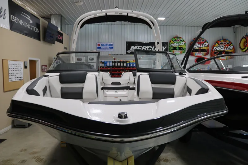 Slide: The Image of 2025 Yamaha Boats 195S in showroom, sleek design, black and white interior. - 3