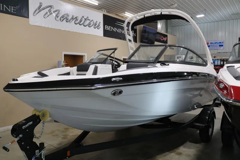Slide: The Image of 2025 Yamaha Boats 195S in showroom, sleek design, white and black color scheme. - 4