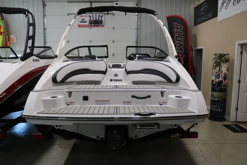 Slide: The Image of 2025 Yamaha Boats 195S, rear view in showroom, sleek design and modern features. - 6