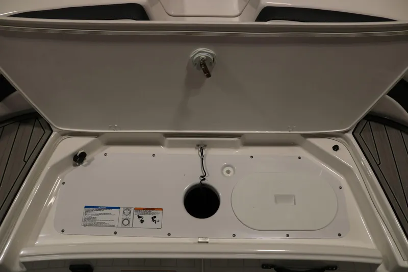Slide: The Image of 2025 Yamaha Boats 195S storage compartment with open lid, showcasing interior features. - 8