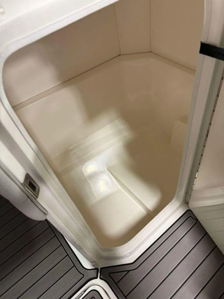 Slide: The Image of 2023 Sea Ray SPX 230 boat interior storage compartment with sleek design. - 10