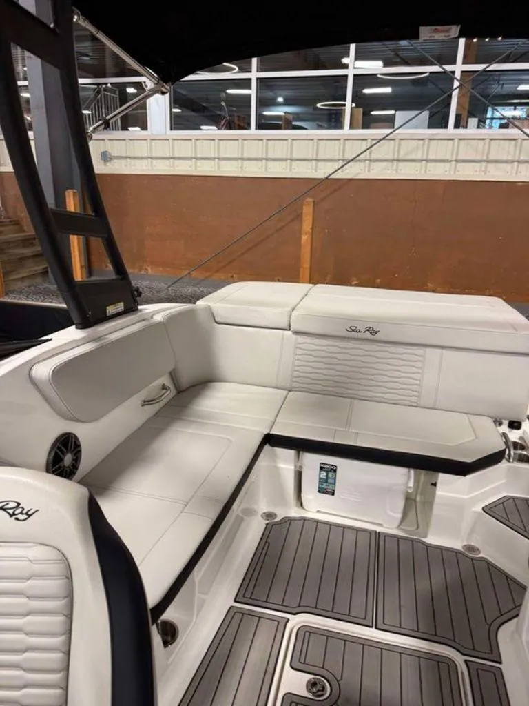 Slide: The Image of 2023 Sea Ray SPX 230 boat interior with white seating and sleek design. - 2