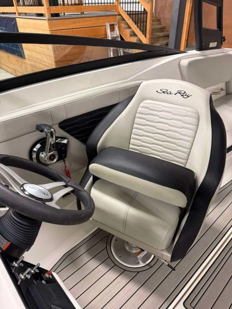 Slide: The Image of 2023 Sea Ray SPX 230 boat interior with steering wheel and captain's seat. - 3