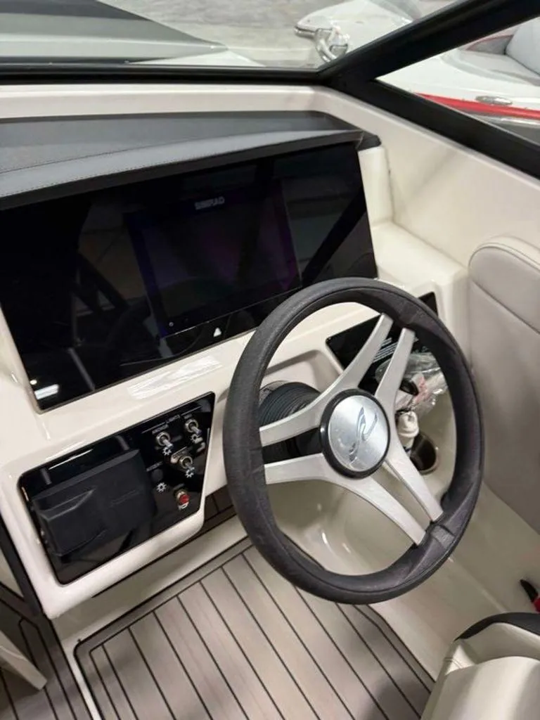 Slide: The Image of 2023 Sea Ray SPX 230 boat dashboard with steering wheel and controls. - 4