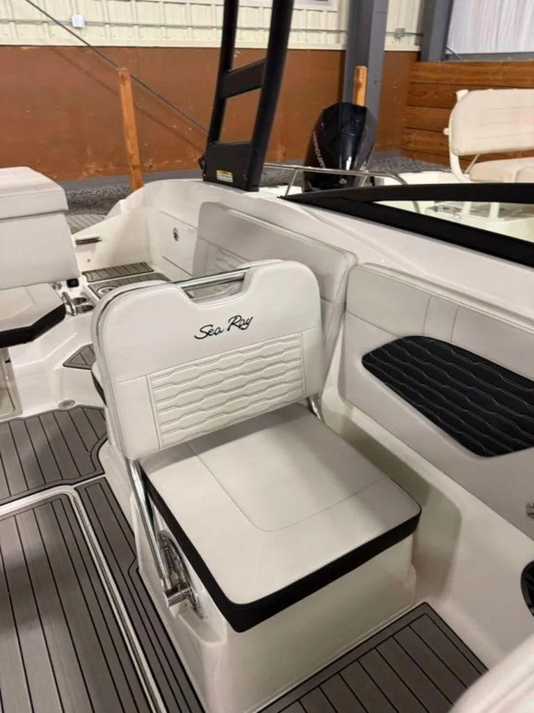 Slide: The Image of 2023 Sea Ray SPX 230 boat interior with white seating and sleek design. - 5