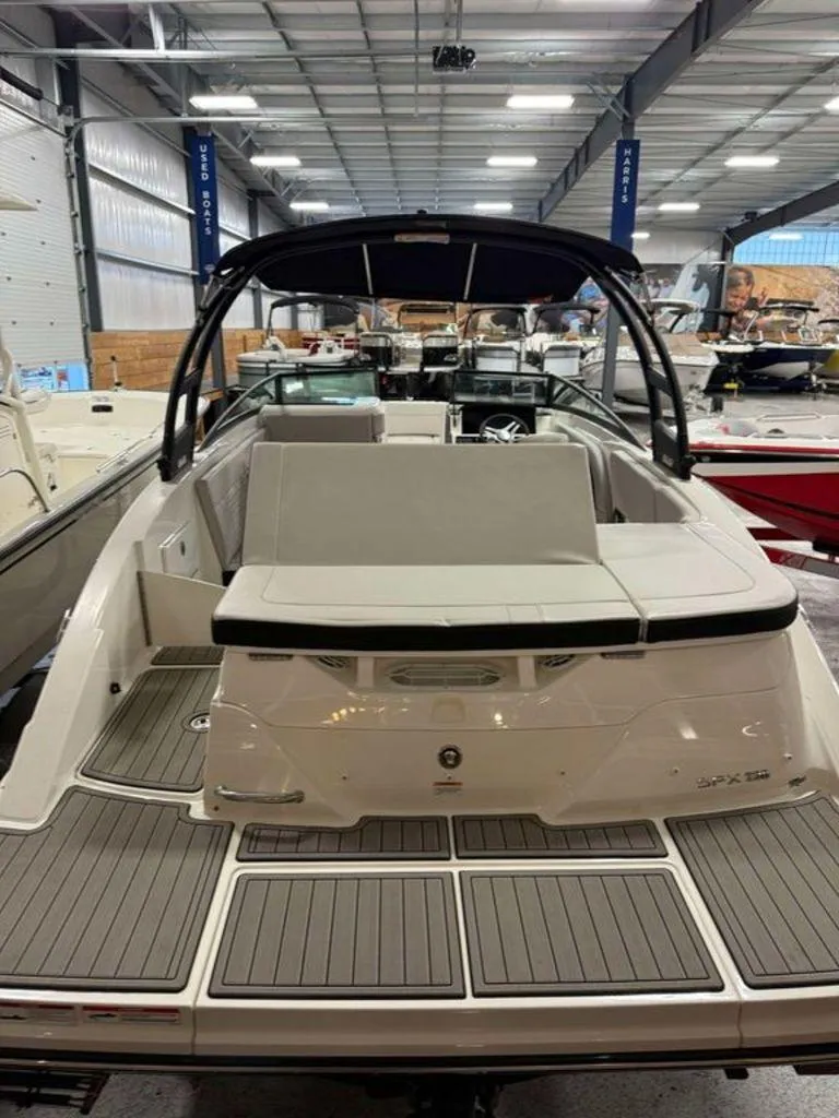 Slide: The Image of 2023 Sea Ray SPX 230 boat in showroom, rear view with seating and deck. - 6